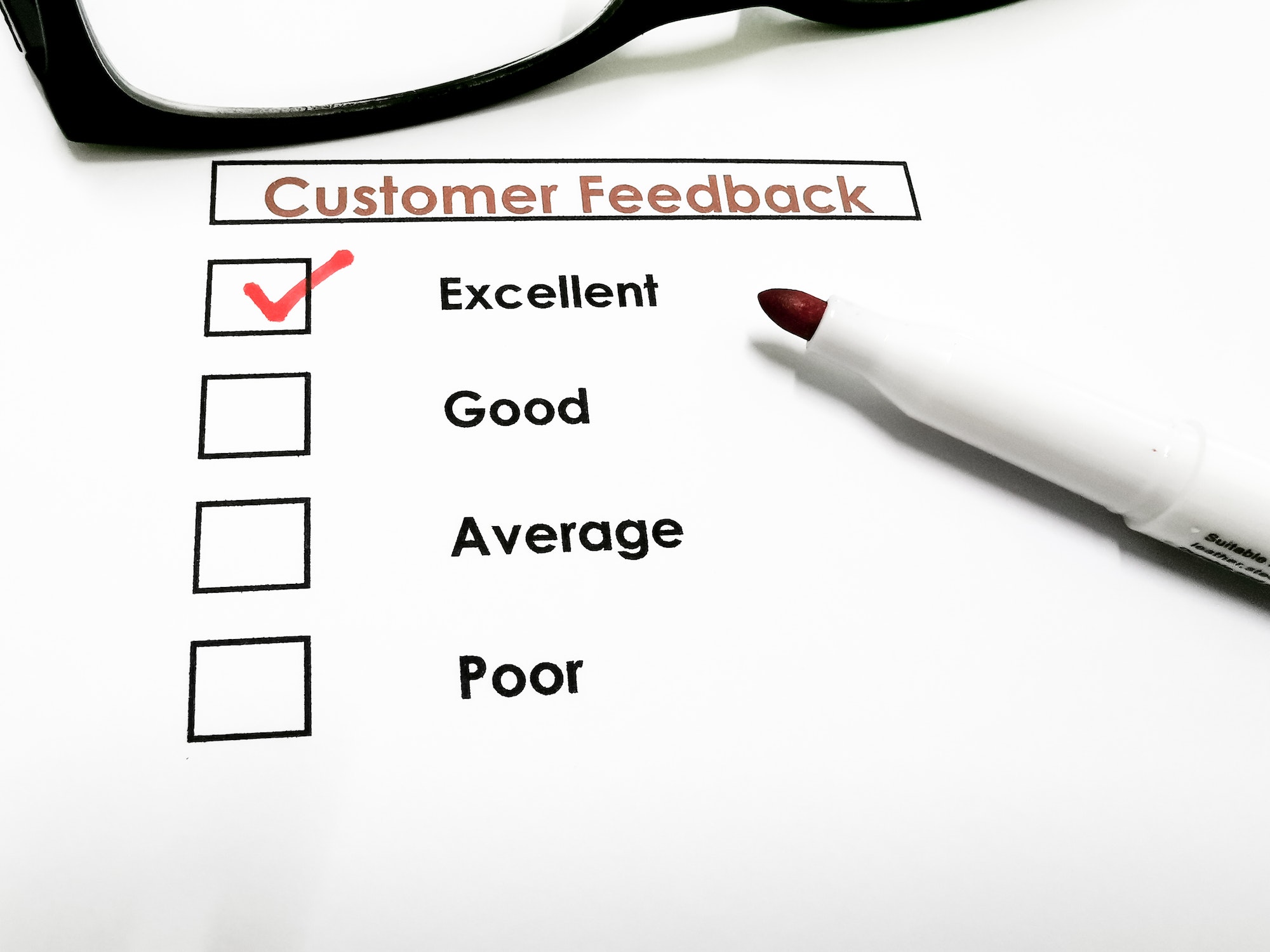 Customer feedback concept with check box and a pen.